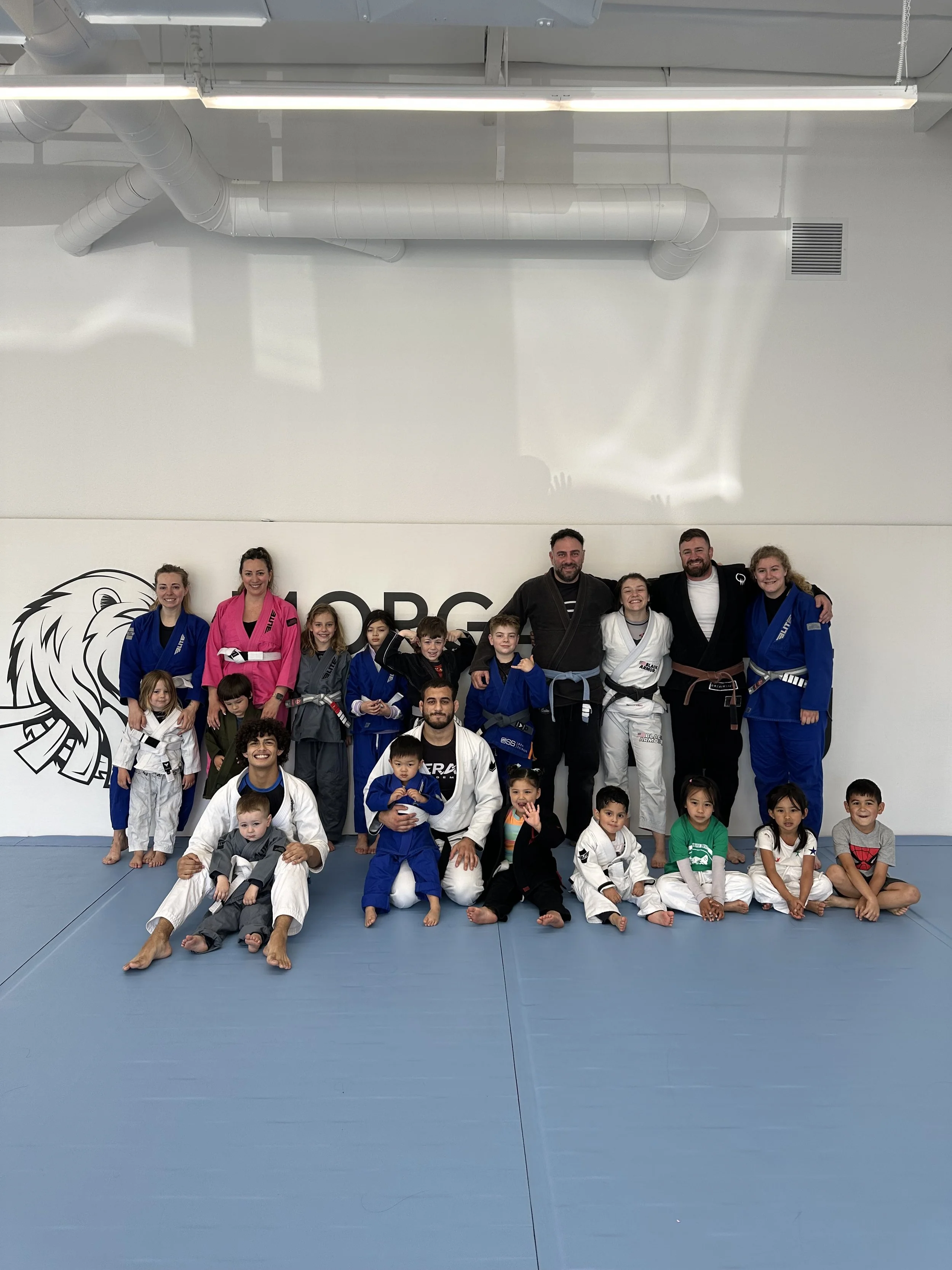 Young students lined up in gis during a youth Jiu Jitsu class
